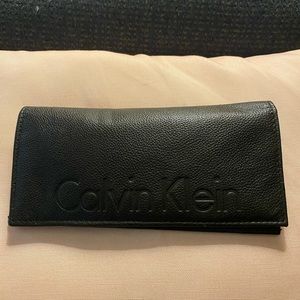 Brown Calvin Klein wallet with zipper pocket.